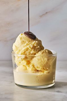 an ice cream sundae is being drizzled with chocolate