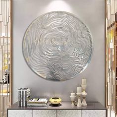 a large circular mirror mounted on the side of a wall above a console table in a living room