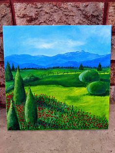 an acrylic painting of a green field with red flowers