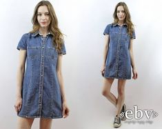 Vintage nineties DENIM MINI DRESS. Snap buttons up front. Chest pockets. 100% cotton. Classic wardrobe staple. Model is 5'9. Her measurements are: bust=34 inches, waist=26 inches, & hips=34 inches. The dress fits as shown on her. We measure on a flat surface from seam to seam. Bust, waist, & hip measurements have already been doubled. We suggest you compare our measurements to a garment you already own and know fits you well to ensure a proper fit. label: gap approximate size: S vintage size on tag: 8 material: 100% cotton across shoulders: 14.75 inches arm length: 6.25 inches bust: 34 inches waist: 31 inches hips: 34 inches length: 32.5 inches VERY IMPORTANT WE DO NOT TAKE RETURNS FOR ITEMS THAT DO NOT FIT. We take extreme care to measure each item accurately, so please take note of the m Vintage Denim Blue Denim Dress With Pockets, Fitted Vintage Button-up Denim Dress, Vintage Short Sleeve Denim Dress With Pockets, Retro Buttoned Denim Dress For Spring, Retro Spring Denim Dress With Buttons, Retro Denim Dress With Buttons For Spring, Vintage Denim Blue Dress With Buttons, Vintage Blue Denim Dress With Pockets, Retro Cotton Denim Dress With Pockets