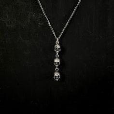 The Skull Trio Necklace features a trio of deteriorating anatomical skulls, stacked atop each other clad with scars, much like the remains of those who make their way to their final burial sites and erode with time. These anatomical skulls are crafted in high detail and shows off the intricacies of the skull from every angle. Skulls have historically been worn as a reminder of one's mortality. Memento mori, latin for “remember that you must die” reminds us of the transient, fleeting nature of li Skulls Stacked, Bp Jewelry, Trio Necklace, Skull Accessories, Edgy Jewelry, Necklace Gothic, Necklaces Silver, Y Necklace, Dope Jewelry