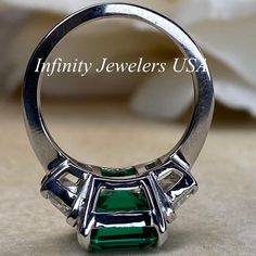 "-Approximate total carat weight: approx. 6.00ctw diamond equivalent #7080 -Center Stone Size: 11x9mm - approx. 4.90ct diamond equivalent -Center Stone Shape: emerald cut -Gem Type: lab created Green Emerald -Stone Clarity: VS2 -Stone Color: F -Moh's Scale: 9 hardness -Side Stones Size: 6x4mm trapezoid approx. 0.55ct. each diamond equivalent -Gem Type: Zonar moissanite -Metal Type and Purity: 14k white gold -Setting: 4 prong tulip setting -Stock Ring Size: 5.75 -Country of Manufacturing: USA (Mi Emerald Wedding Rings, Emerald Wedding, Lab Created Emerald, White Gold Set, Ladies Ring, Emerald Engagement, Emerald Stone, Emerald Engagement Ring, Ring Unique