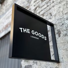 the goods sign is hanging on the wall