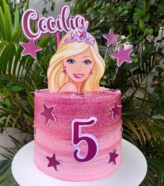 a birthday cake with a barbie doll on top