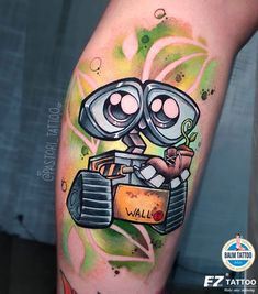 a cartoon character is on the leg of a person with tattoos that say wall - e