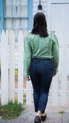 The 100% cotton blouse is a slightly fitted button up style in a beautiful green tone with the best selling Poppy print in a delicate light pink. What sets this blouse apart is the dainty ruffles with lace and pleats that gives it a little extra flair. Wear it with jeans for a weekend adventure, pair with slacks for a day in the office, or dress it up with a faux leather skirt for a more edgy look. Ready to ship! Please allow 1-2 business days to process your order and ship. Details: 100% cotton Feminine Green Tops For Workwear, Casual Green Top With Ruffled Collar, Fitted Green Cotton Blouse, Casual Green Tops With Ruffled Collar, Green Top With Ruffled Collar And Details, Green Ruffled Long Sleeve Blouse, Green Ruffled Tops For Work, Green Ruffled Tops For Workwear, Casual Green Blouse With Ruffled Collar