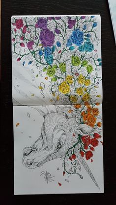 a drawing of a unicorn with flowers on it's head and in the background