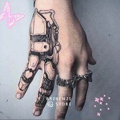 a hand with a robot tattoo on it