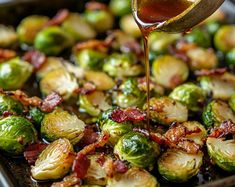 brussel sprouts with bacon and maple syrup being drizzled on them