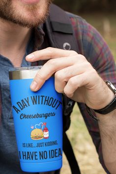 a man holding a blue cup with writing on it