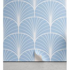 a blue and white wallpaper with an art deco style design on the back ground