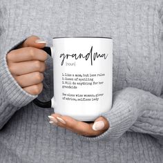 a woman holding a coffee mug with the words grandma written on it in cursive writing