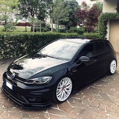 a black car parked in front of a house