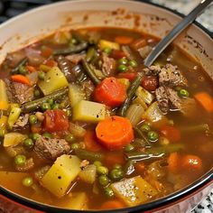 a bowl filled with meat and vegetables on top of a table