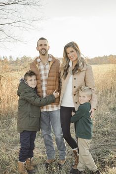 a family posing for a photo in an open field