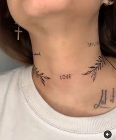 a woman wearing a cross and love tattoo on her neck