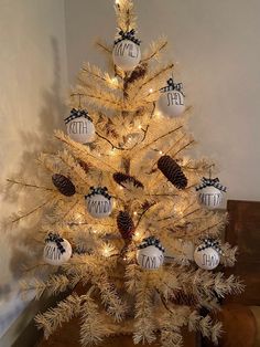 a white christmas tree with black and white ornaments