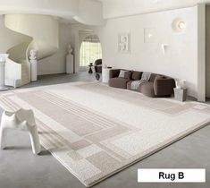 a large rug is in the middle of a living room with white walls and flooring