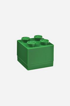 a green lego brick with four small bricks