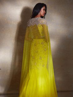 Yellow power shoulder crop featuring hand-embellished ivory camellia flowers paired with a tiered georgette lehenga and embellished waistband with ivory drops & a ruffled dupatta.From Shloka Khialani's Winter Sun collection.DELIVERY TIMEPlease allow 6-8 weeks for your outfit to arrive.FABRIC DETAILSGeorgette, NetProfessional cleaning only. Reception Gown With Ruffles In Georgette, Traditional Drape Wedding Gown With Ruffles, Anarkali Organza Dress With Cape Sleeves, Festive Organza Dress With Cape Sleeves, Floor-length Ruffled Anarkali Set For Wedding, Designer Gown With Ruffles, Designer Organza Dresses With Ruffles, Traditional Ruffled Organza Gown, Organza Lehenga With Dupatta And Cape Sleeves