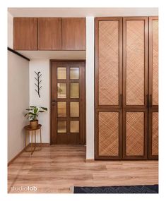 an entryway with wooden doors and wood flooring