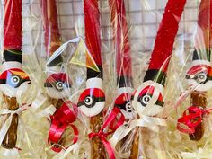 some candy sticks are wrapped in plastic and tied with red ribbon to look like pokemon pikachu