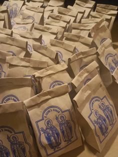 brown paper bags with blue designs on them sitting on a counter top next to each other