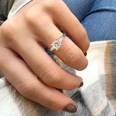 a woman's hand with a diamond ring on it