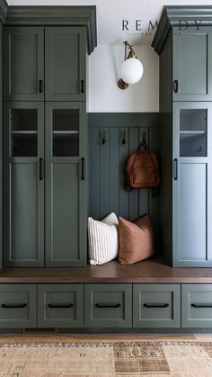 a room with green cabinets and a brown bag on the bench in front of it