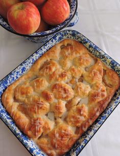 an apple pie and bowl of apples on a table