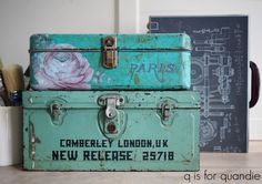 two old suitcases are stacked on top of each other with the words paris painted on them