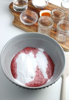 a bowl filled with powdered sugar on top of a wooden cutting board next to other ingredients