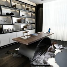 a desk with a laptop on it in front of a book shelf filled with books