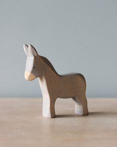 a small wooden toy horse on a table