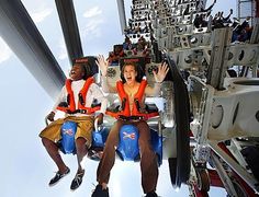 two people are sitting on a roller coaster