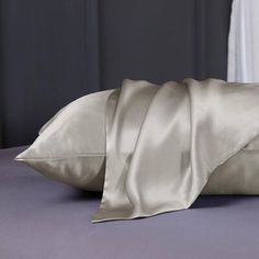 a bed with two pillows on top of it