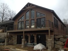 a large house with lots of windows on the front and side of it, under construction