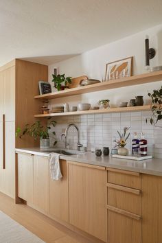 the kitchen is clean and ready for us to use it's natural wood cabinetry