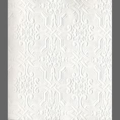 a white wallpaper with an intricate pattern on it