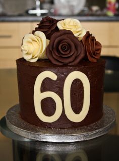 a close up of a cake on a table with the number 60 written in frosting