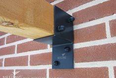 a close up of a wooden beam on a brick wall