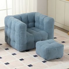 a blue chair and ottoman in a room