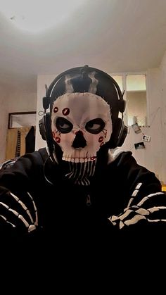 a man wearing a skeleton mask and headphones