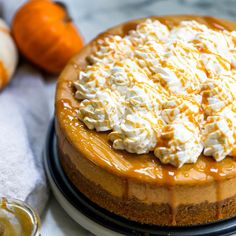 a cheesecake topped with whipped cream and caramel