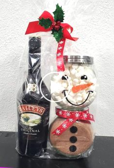 a glass jar filled with marshmallows and a bottle of bailey's