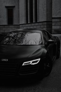 a black car parked in front of a building