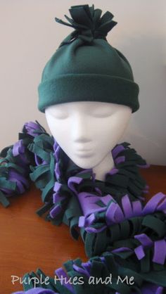 a mannequin wearing a green and purple hat with ruffles on it