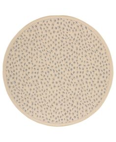 a round rug with dots on the bottom in beige and grey colors, against a white background