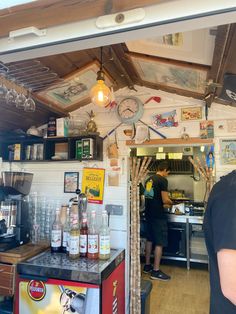 a man standing in front of a kitchen filled with food