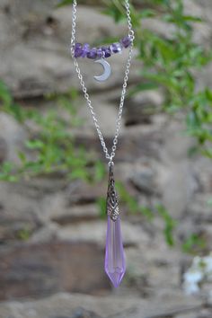 PLEASE read my shop announcement before placing an order so you know what to expect right now. Plus, when ordering from outside Europe, don't forget to provide a phone number for the courier to ensure the fastest and smoothest delivery. Statement boho witchy layered necklace featuring an amethyst beaded bar with dainty steel crescent moon, and a mystical amethyst color crystal pendulum. This is a short layered necklace, shortest layer with the amethyst beads and the moon is almost choker style, Mystical Dangle Necklaces With Moon Charm, Mystical Moon Charm Dangle Necklace, Mystical Dangle Necklace With Moon Charm, Mystical Purple Necklace For Festivals, Mystical Sterling Silver Crystal Necklace With Moon Charm, Adjustable Purple Moon Phase Jewelry, Spiritual Crescent Wire Wrapped Necklaces, Spiritual Lavender Wire Wrapped Necklaces, Bohemian Crescent Crystal Necklace With Moon Charm